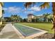 Outdoor shuffleboard court on grass with palm trees and colorful condos in the background under a blue sky at 3083 Key Lime Loop, Kissimmee, FL 34747