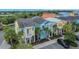 Street view of colorful homes with well-manicured lawns and palm trees at 3083 Key Lime Loop, Kissimmee, FL 34747