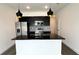 Modern kitchen with black countertops, stainless appliances, and pendant lighting at 3259 Energy Dr, Kissimmee, FL 34747