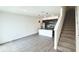 Open-concept living area with modern kitchen, stainless appliances, and staircase at 3259 Energy Dr, Kissimmee, FL 34747
