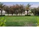 Spacious backyard featuring lush green grass, mature trees, and tranquil water views at 3382 Fernlake Pl, Longwood, FL 32779