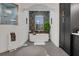 Beautiful bathroom featuring a standalone tub beneath a window, complemented by dark cabinetry and unique tile work at 3382 Fernlake Pl, Longwood, FL 32779