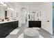 Luxurious bathroom with dual vanities, modern fixtures, and a central ottoman for added comfort at 3382 Fernlake Pl, Longwood, FL 32779