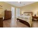 Bedroom with beautiful hardwood floors and ensuite bathroom featuring modern lighting fixtures at 3382 Fernlake Pl, Longwood, FL 32779