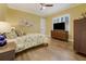 Comfortable bedroom featuring hardwood floors, a ceiling fan, and a brightly lit window at 3382 Fernlake Pl, Longwood, FL 32779