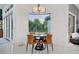 Cozy breakfast nook featuring a round table, chairs, and large window with garden views at 3382 Fernlake Pl, Longwood, FL 32779