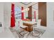 Well-lit dining room with modern decor, designer lighting, and large windows with red drapes at 3382 Fernlake Pl, Longwood, FL 32779