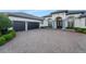 A luxurious home featuring a wide brick driveway, a three car garage and mature landscaping at 3382 Fernlake Pl, Longwood, FL 32779