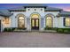 Close up of the home's entryway with double doors, brick walkway, and beautifully maintained landscaping at 3382 Fernlake Pl, Longwood, FL 32779
