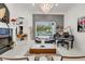 Bright living room featuring modern decor, fireplace, grand piano, and a view of the outdoor pool at 3382 Fernlake Pl, Longwood, FL 32779