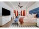 Beautiful main bedroom with tray ceiling, orange drapes, and elegant furnishings at 3382 Fernlake Pl, Longwood, FL 32779