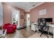 Home office featuring wood floors, pink walls, and comfortable seating, perfect for remote work at 3382 Fernlake Pl, Longwood, FL 32779