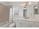Bathroom features a shower-tub combo, large vanity, and window providing natural light at 3514 Golfview Blvd, Orlando, FL 32804