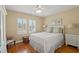 Comfortable bedroom featuring hardwood floors, white wood trim, and two large windows at 3514 Golfview Blvd, Orlando, FL 32804