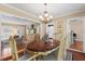 Dining room featuring a chandelier, hardwood table, and an open view of the living room at 3514 Golfview Blvd, Orlando, FL 32804