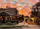 Outdoor patio with pergola for shaded seating and dining, set against a fiery sunset background at 3514 Golfview Blvd, Orlando, FL 32804