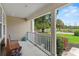 Inviting front porch with a bench, decorative stool, and a beautiful view of the manicured front lawn at 3514 Golfview Blvd, Orlando, FL 32804