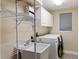 Well-equipped laundry room with modern washer, dryer, sink and shelving at 3514 Golfview Blvd, Orlando, FL 32804