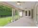 Covered outdoor patio with ceiling fans, views of the lawn, and access to the yard at 3514 Golfview Blvd, Orlando, FL 32804
