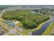 Aerial view of community amenities including courts, parking, and a lush lake with walking path in a Gathering-friendly location at 4307 Pebbles Throw Dr, Kissimmee, FL 34746