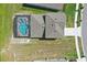 An aerial view of the house, with a screened pool and patio, showcasing the home's roof and backyard at 4307 Pebbles Throw Dr, Kissimmee, FL 34746