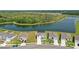 Aerial view of the neighborhood featuring beautiful homes, a tranquil lake, and lush greenery at 4307 Pebbles Throw Dr, Kissimmee, FL 34746