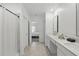 Bright bathroom featuring dual sinks, white cabinets, and a shower-tub combo at 4307 Pebbles Throw Dr, Kissimmee, FL 34746