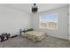 Bedroom featuring neutral walls, plush carpet, and a modern black chandelier at 4307 Pebbles Throw Dr, Kissimmee, FL 34746