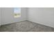 Empty bedroom features carpet and a window at 4307 Pebbles Throw Dr, Kissimmee, FL 34746