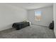 Bedroom featuring neutral walls, plush carpet, and a window with great outdoor light at 4307 Pebbles Throw Dr, Kissimmee, FL 34746