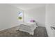 Cozy bedroom boasts neutral carpet and walls with a view of the lush outdoors at 4307 Pebbles Throw Dr, Kissimmee, FL 34746