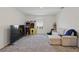 Spacious bonus room featuring plush carpet, a comfortable sectional, and arcade games at 4307 Pebbles Throw Dr, Kissimmee, FL 34746