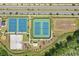 Aerial shot of a basketball court, tennis court, volleyball court, playground, and picnic areas, next to a parking lot at 4307 Pebbles Throw Dr, Kissimmee, FL 34746