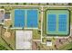A high shot over the basketball and tennis courts, sand volleyball and exercise area, along a community street at 4307 Pebbles Throw Dr, Kissimmee, FL 34746