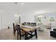 Bright dining area featuring seating for six, modern chandelier, and access to the living area and backyard at 4307 Pebbles Throw Dr, Kissimmee, FL 34746
