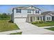 Beautiful two-story home featuring a well-maintained lawn and a two car garage at 4307 Pebbles Throw Dr, Kissimmee, FL 34746