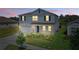 Charming two-story home with a manicured lawn, attached garage, and a welcoming entryway at 4307 Pebbles Throw Dr, Kissimmee, FL 34746