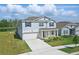 Charming two-story home boasts a well-maintained lawn and landscaping for excellent curb appeal at 4307 Pebbles Throw Dr, Kissimmee, FL 34746