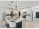 Modern kitchen with white cabinetry, stainless steel appliances, and a large center island with seating at 4307 Pebbles Throw Dr, Kissimmee, FL 34746