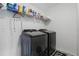 Laundry room includes modern washer and dryer units, and shelving for storage at 4307 Pebbles Throw Dr, Kissimmee, FL 34746