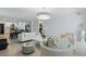 Bright and airy living room with modern furniture and open access to the kitchen and dining areas at 4307 Pebbles Throw Dr, Kissimmee, FL 34746