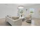 Bright living room with modern white furniture, a view of the pool area, and stylish decor at 4307 Pebbles Throw Dr, Kissimmee, FL 34746