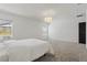 Bright main bedroom featuring neutral walls, plush carpet, and large windows with water views at 4307 Pebbles Throw Dr, Kissimmee, FL 34746