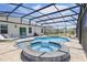A luxurious screened-in pool and spa area with comfortable lounge chairs perfect for relaxation at 4307 Pebbles Throw Dr, Kissimmee, FL 34746