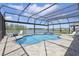Entertain in the screened pool area with a spa and scenic lake views, perfect for Florida living at 4307 Pebbles Throw Dr, Kissimmee, FL 34746