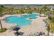Community pool with lounge chairs surrounded by palm trees offers a resort feel at 4307 Pebbles Throw Dr, Kissimmee, FL 34746