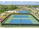 Aerial view showcases the tennis, and basketball courts, volleyball area, and playground in a well-maintained community at 4307 Pebbles Throw Dr, Kissimmee, FL 34746