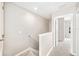 Neutral hallway with carpeted floors leads to the living spaces and bedrooms upstairs at 5004 Ashford Falls Ln, Oviedo, FL 32765