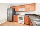 Well-equipped kitchen with stainless steel refrigerator and appliances, wood cabinets, and plenty of counter space at 5004 Ashford Falls Ln, Oviedo, FL 32765