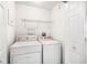 Laundry room featuring a white washer and dryer, plus a wire shelf and a white door at 5004 Ashford Falls Ln, Oviedo, FL 32765